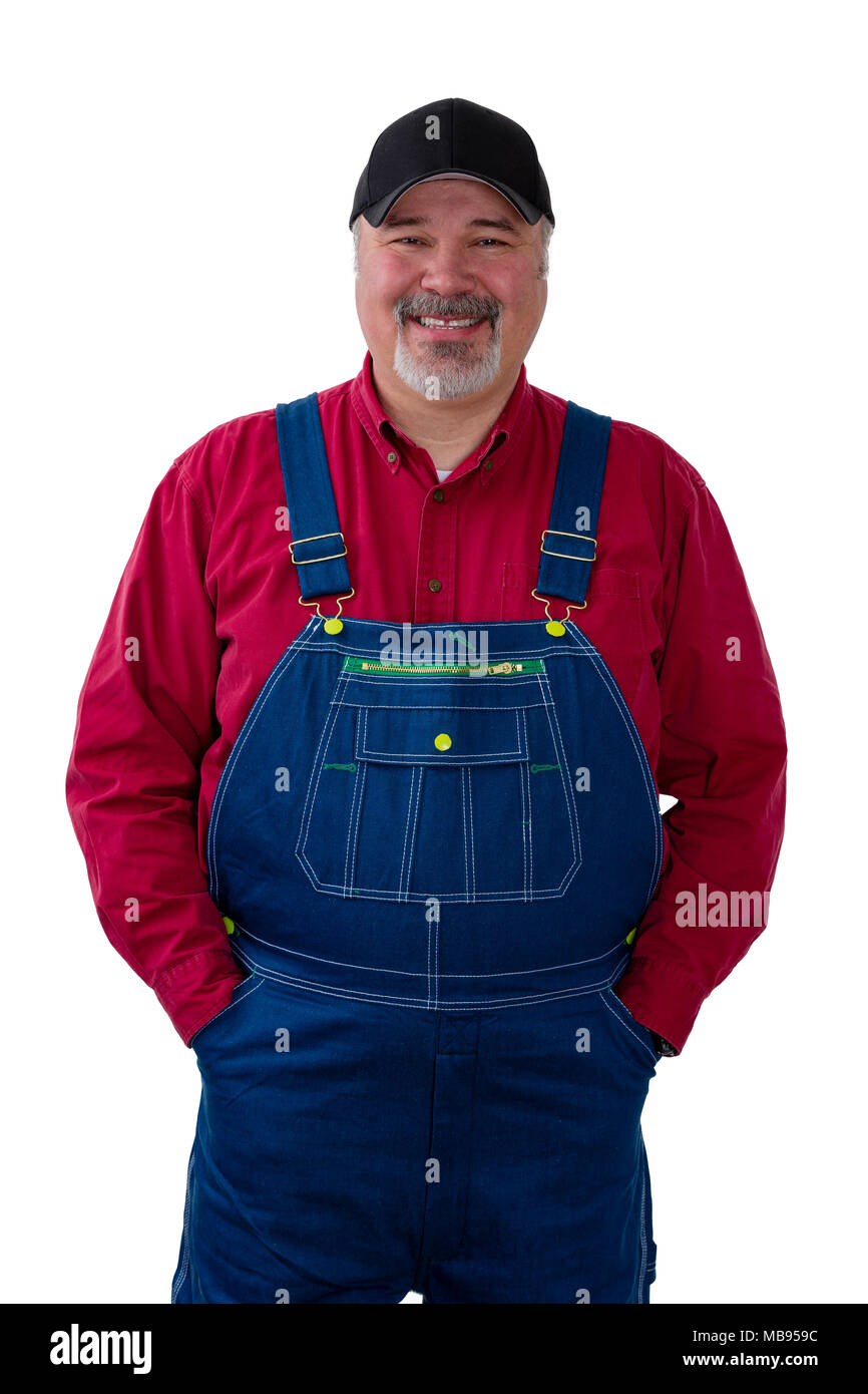 Cheerful farm worker wearing dungarees standing against white background Stock Photo