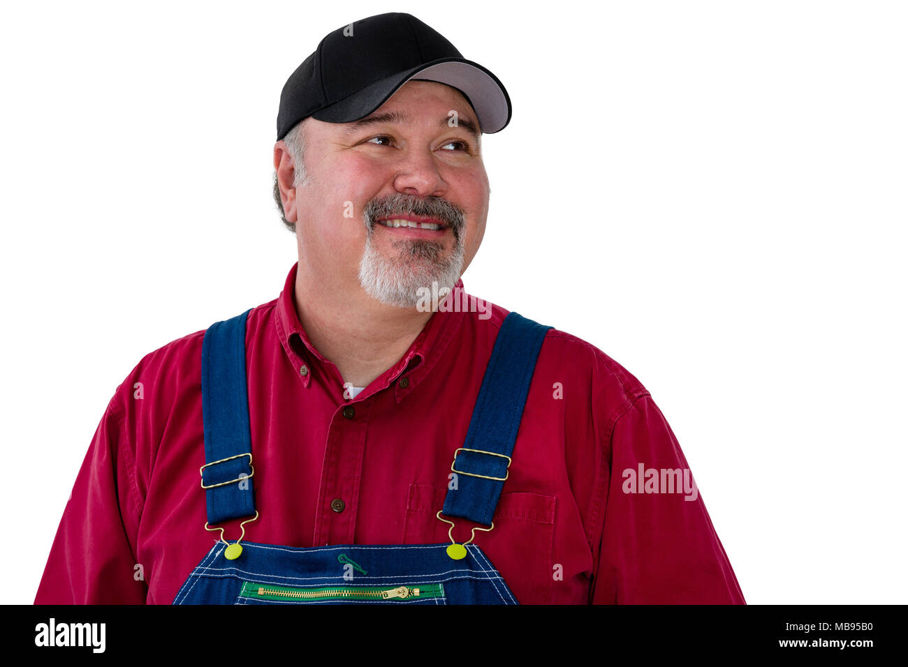 Cheerful male worker wearing dungarees standing against white background Stock Photo