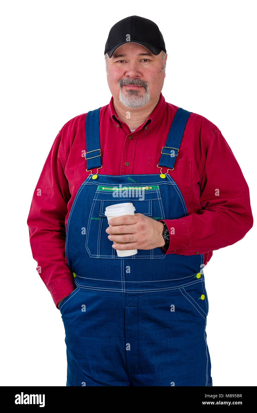 Thoughtful farmer or worker in denim dungarees and cap standing holding a  takeaway coffee gazing intently at the camera isolated on white Stock Photo  - Alamy