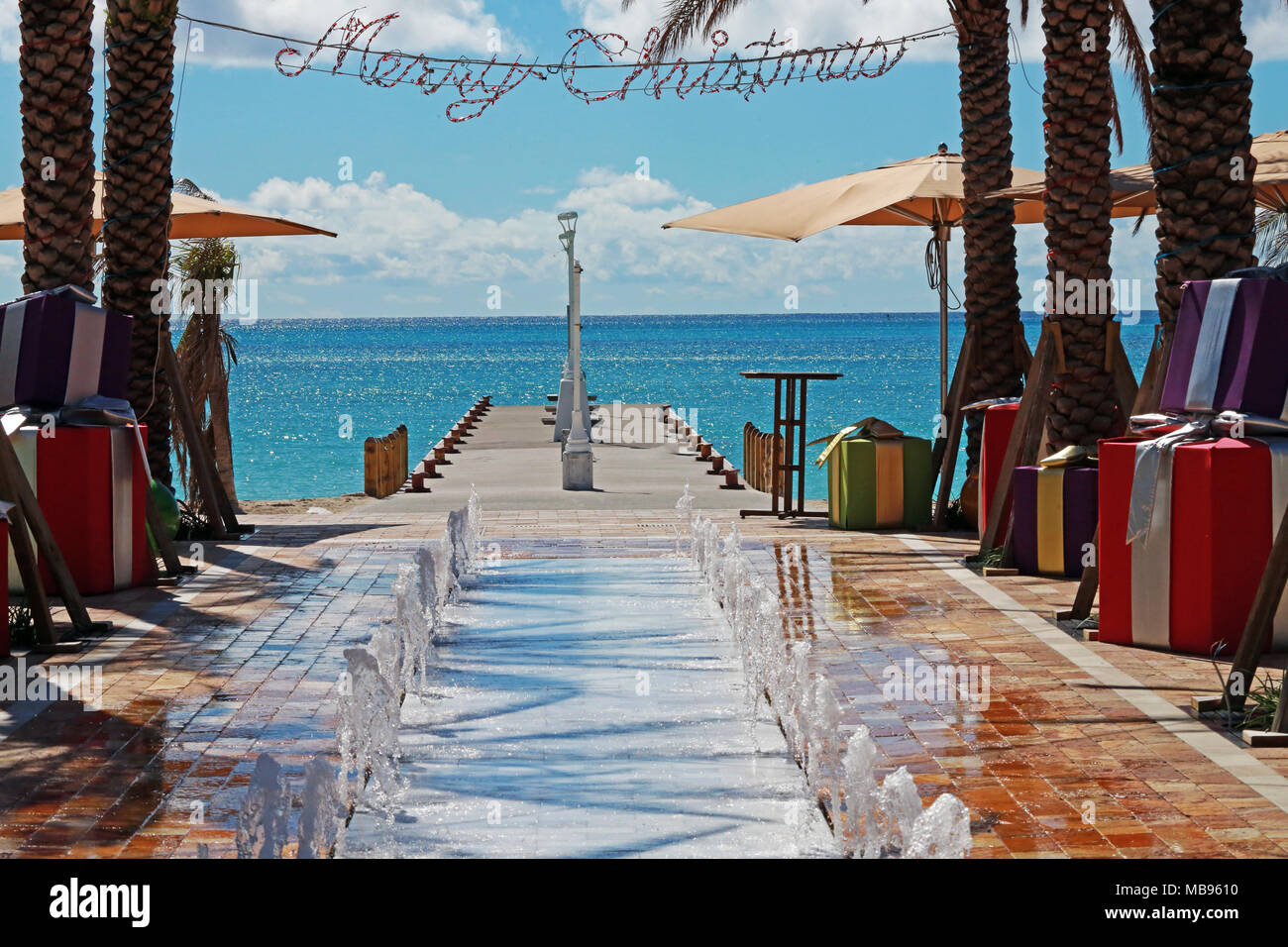 water fountain flanked by Christmas presents and Merry Christmas light