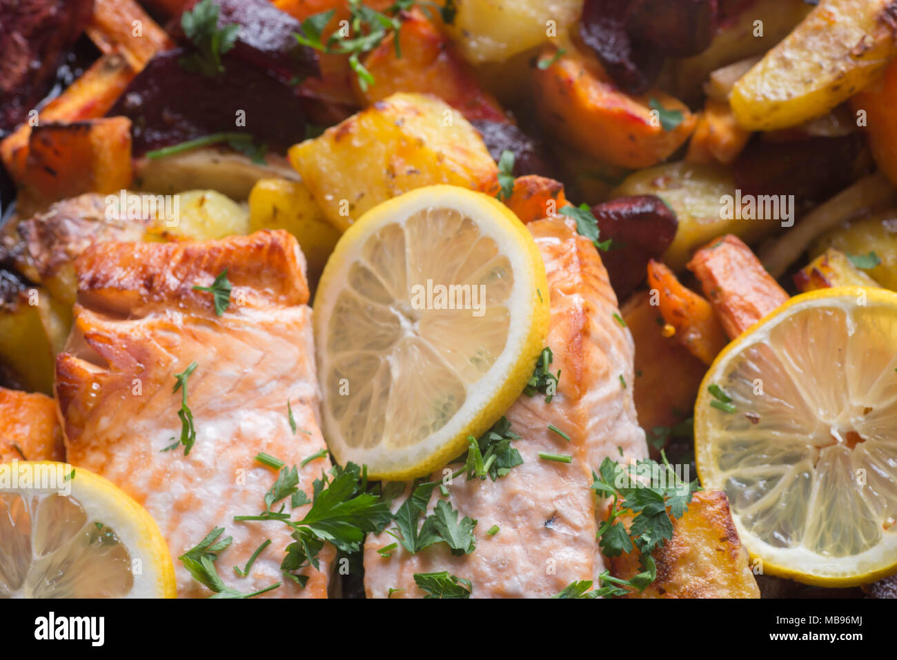 salmon baked with vegetables in oven macro Stock Photo Alamy