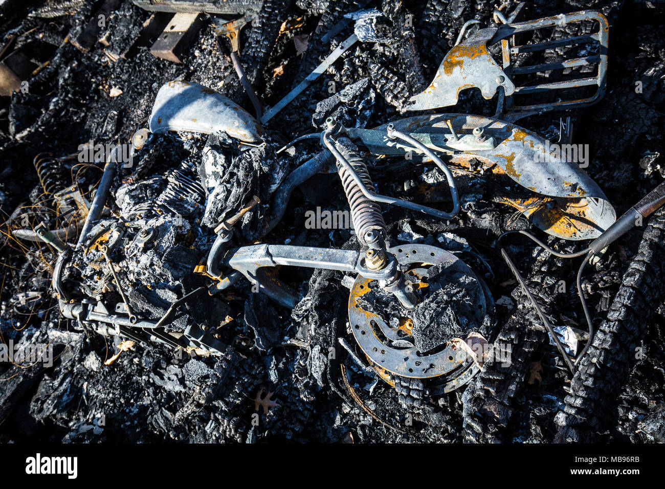 Burned motorcycle after an accident lying down Stock Photo - Alamy