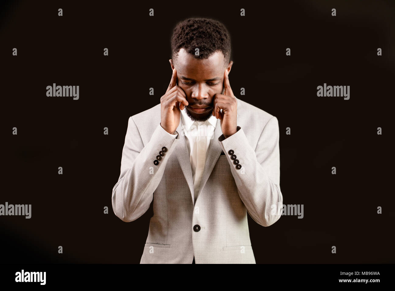 Afro stylish guy touching his temples Stock Photo