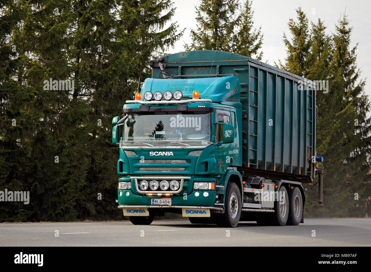 SALO, FINLAND - APRIL 8, 2018: Green Scania P420 refuse collection roll on roll off truck beautifully customized with auxiliary lighting accessories o Stock Photo