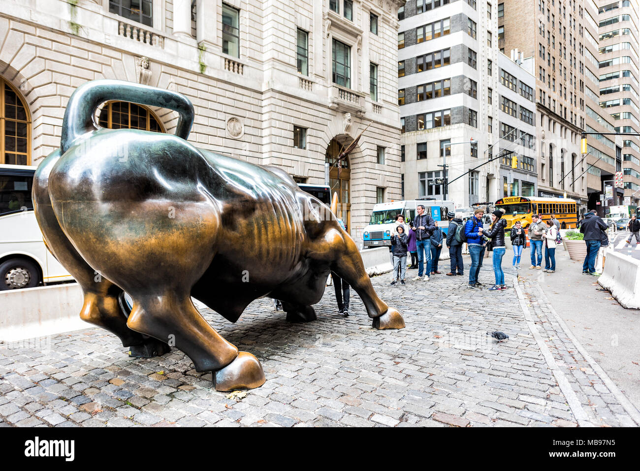 New York City, USA - October 30, 2017: Wall Street stock exchange charging, metal, bronze statue of bull in NYC Manhattan lower financial district dow Stock Photo