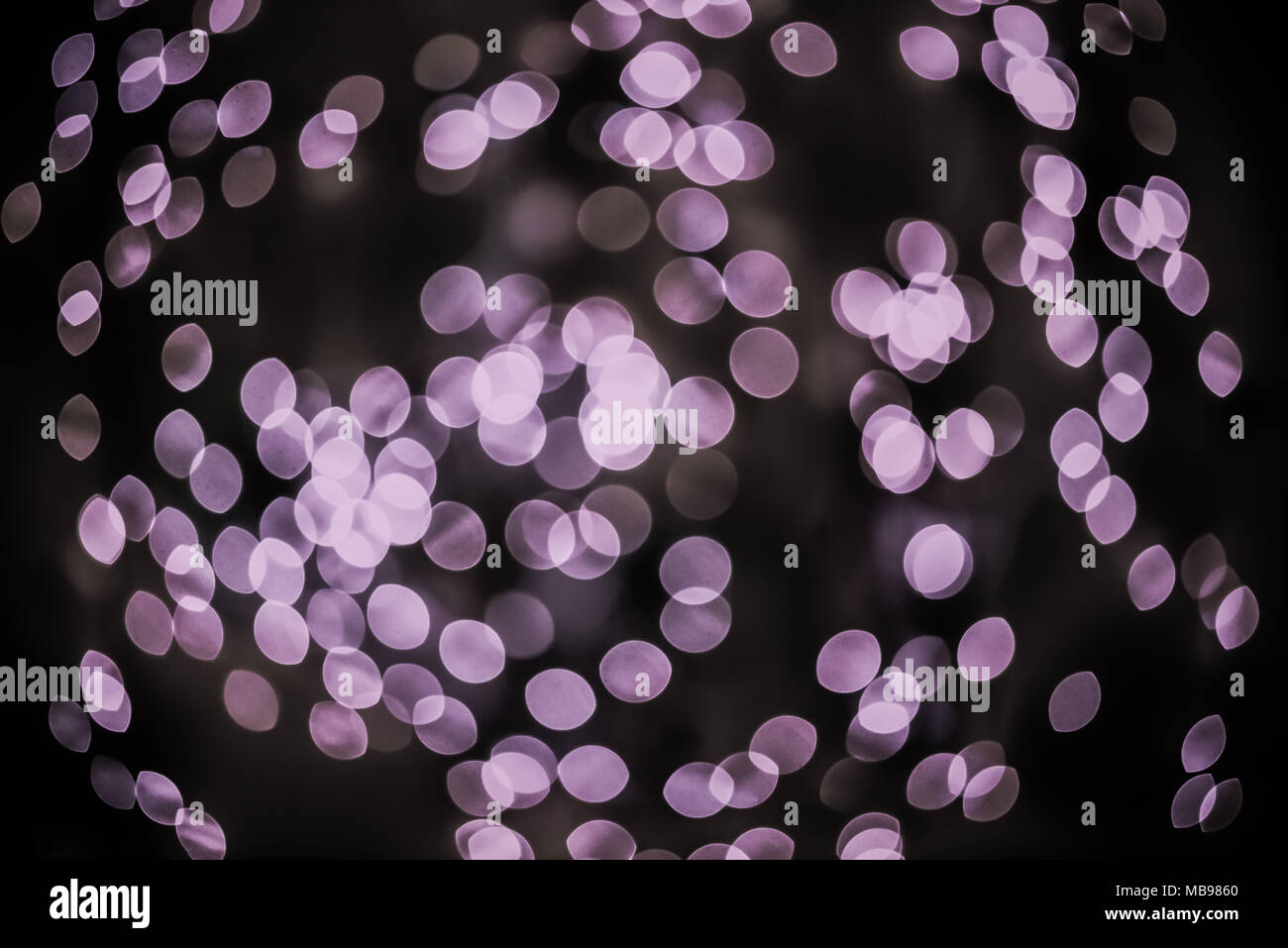 Bokeh background glowing oval shaped glow dark light purple empty Stock Photo