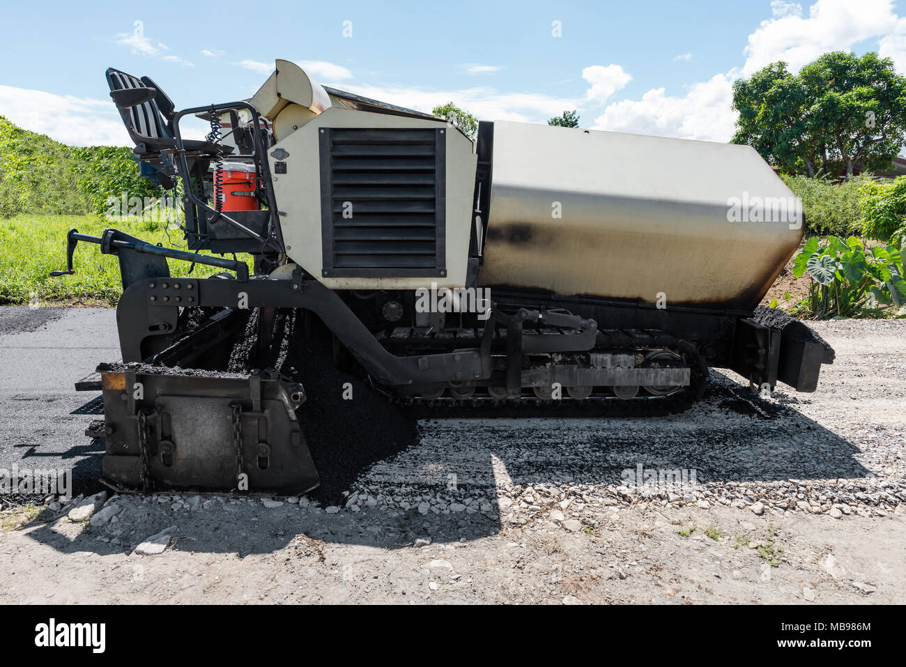 Asphalt road paver paving machine construction industry roadwork repair Stock Photo