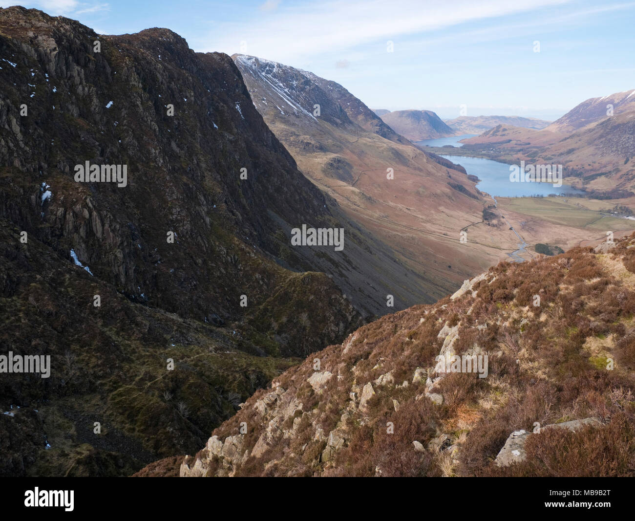 View down the ravine of Black Beck, under the crags of Haystacks to Warnscale Bottom and Buttermere, with Crummock Water & Mellbreak beyond. Stock Photo