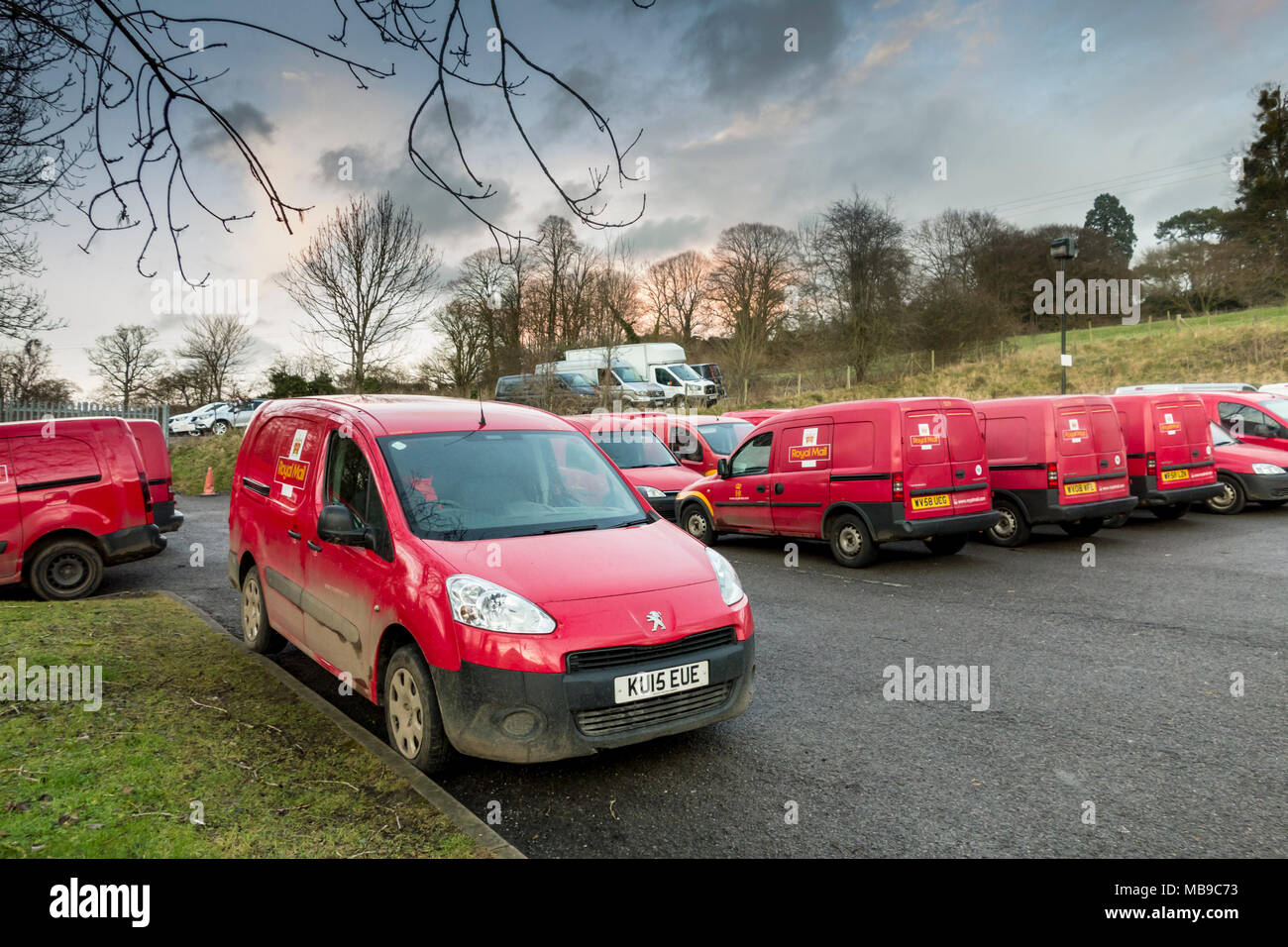 Royal Mail red delivery mini vans parked at sorting office car park, UK
