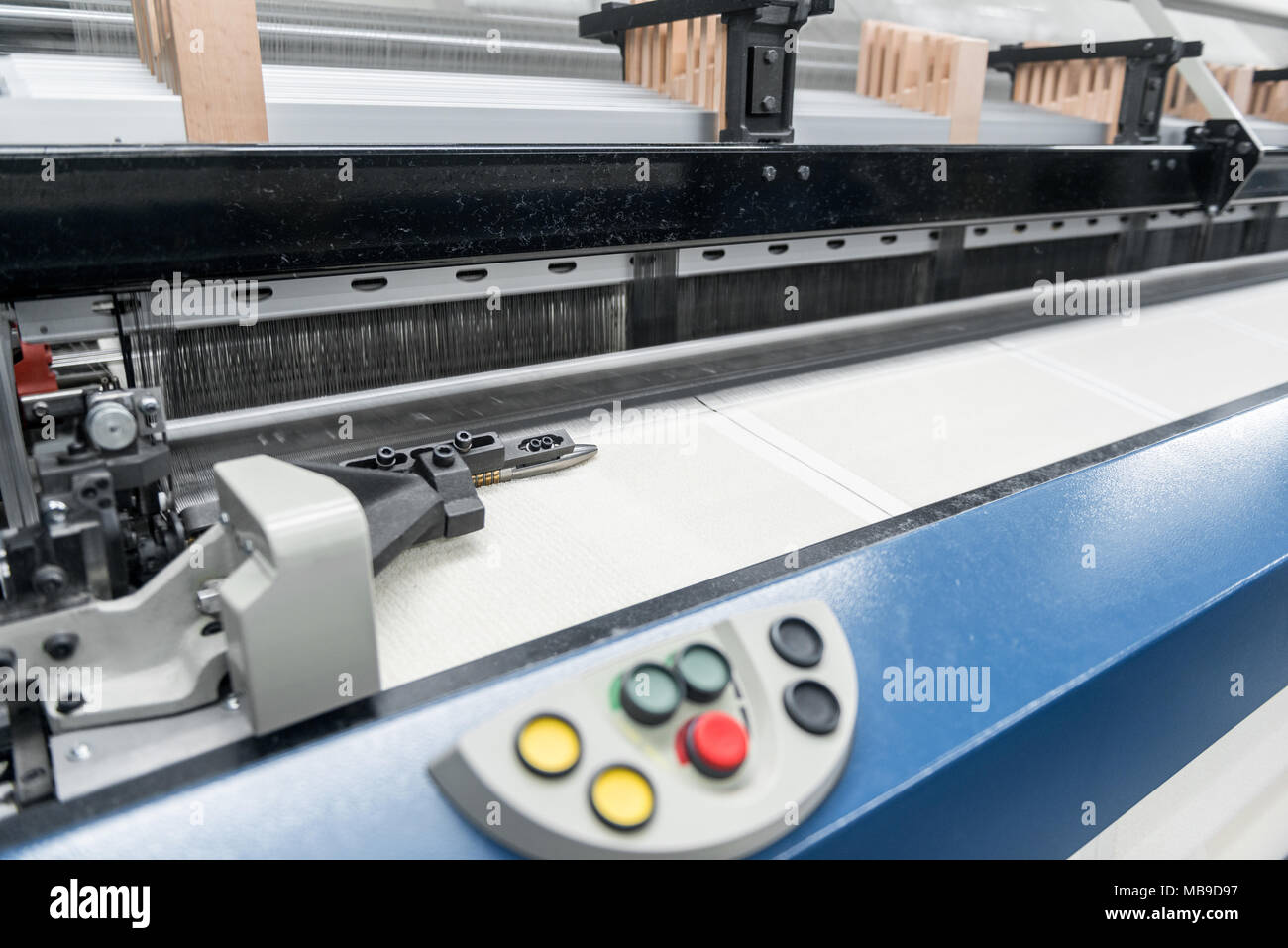weaving loom at a textile factory, closeup. industrial fabric