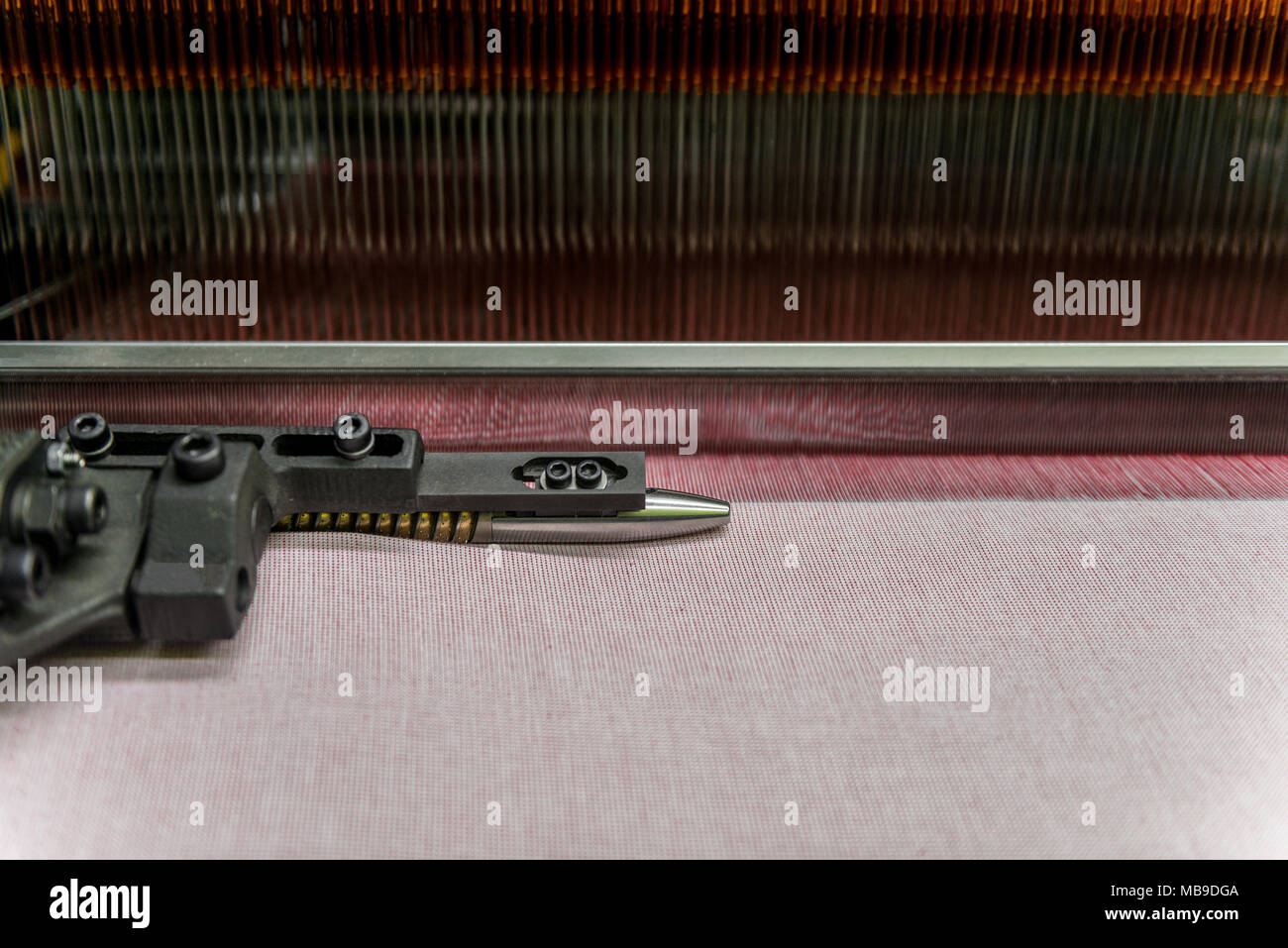 weaving loom at a textile factory, closeup. industrial fabric