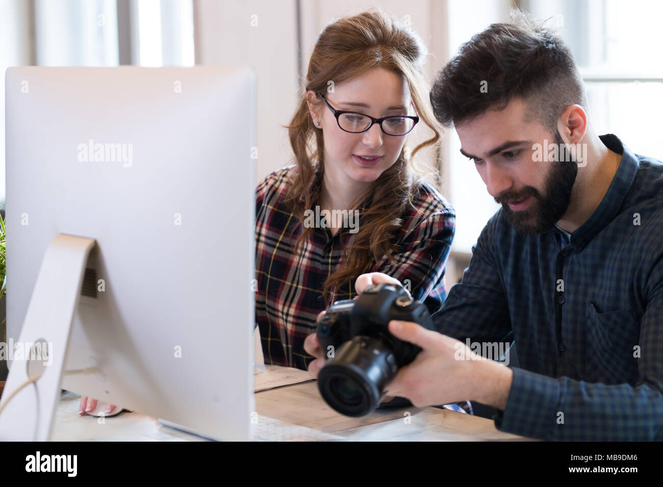 Two young designers working in modern office Stock Photo