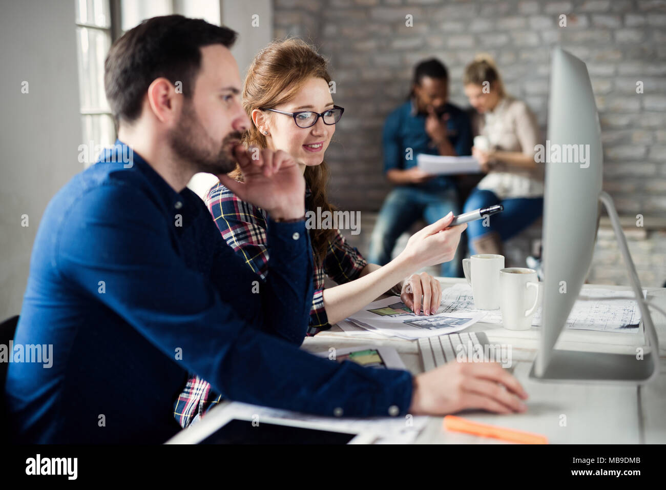 Young architects working on project in office Stock Photo