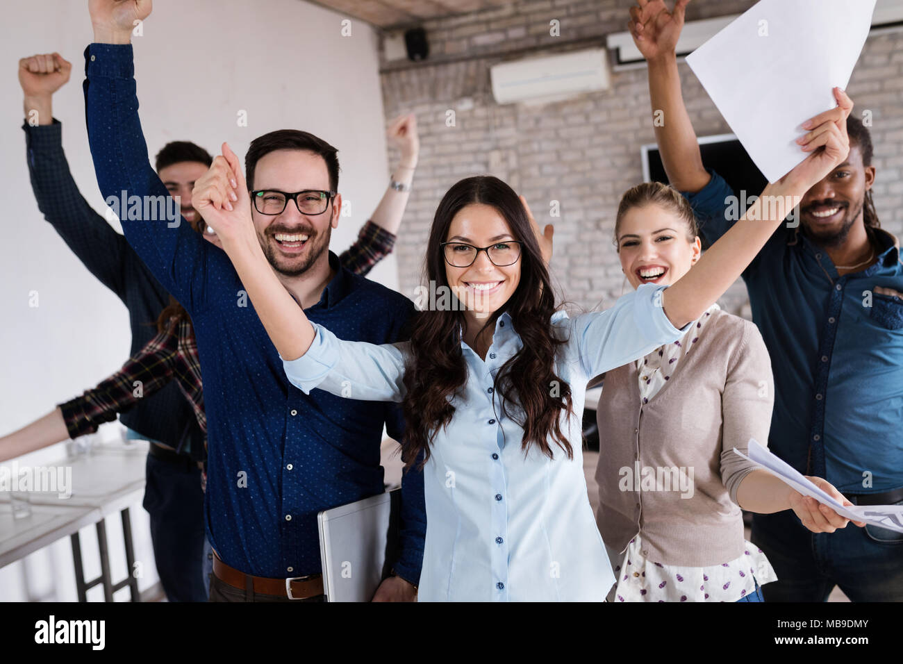 Portrait of successful business team posing in office Stock Photo - Alamy