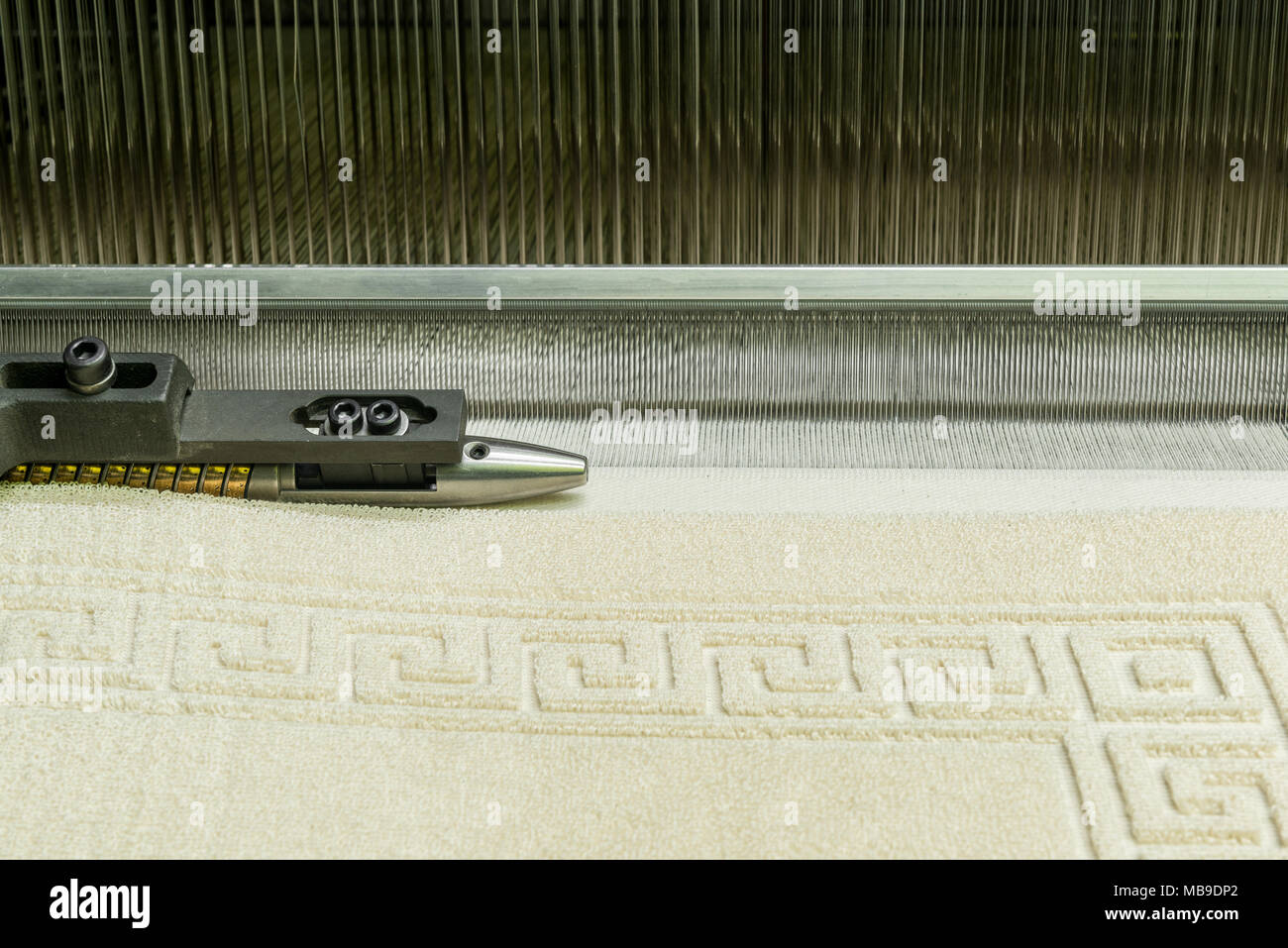 weaving loom at a textile factory, closeup. industrial fabric