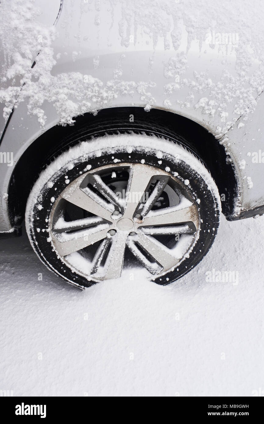 Close-up of a car wheel stranded in a snowdrift - John Gollop Stock Photo