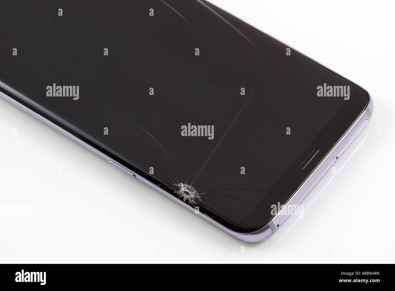 New and modern smartphone with screen has cracks, Touch screen smartphone with broken screen isolated on white background, with clipping path. Stock Photo