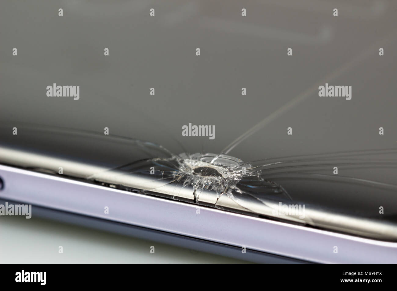 New and modern smartphone with screen has cracks, Touch screen smartphone with broken screen isolated on white background, with clipping path. Stock Photo