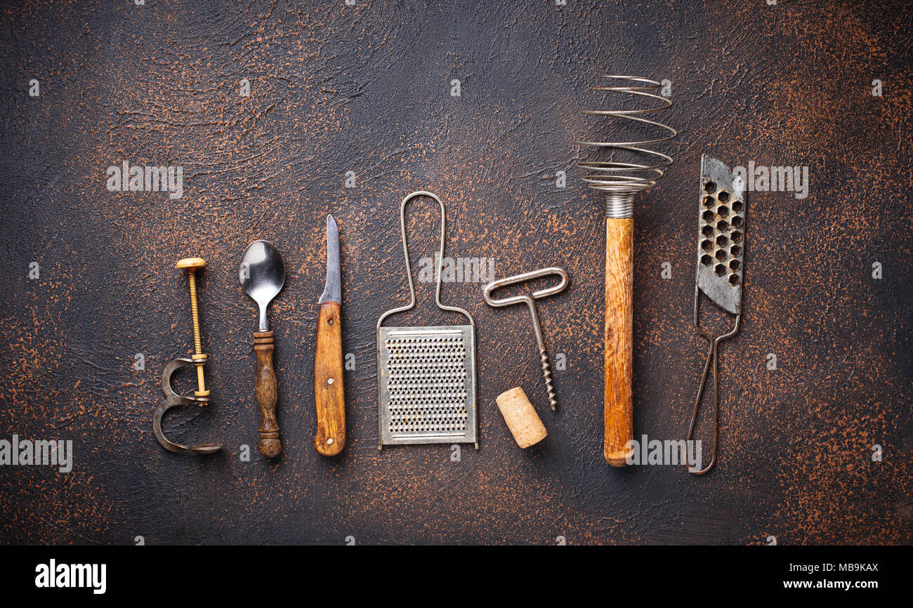 Old vintage kitchen utensils on rusty background Stock Photo - Alamy