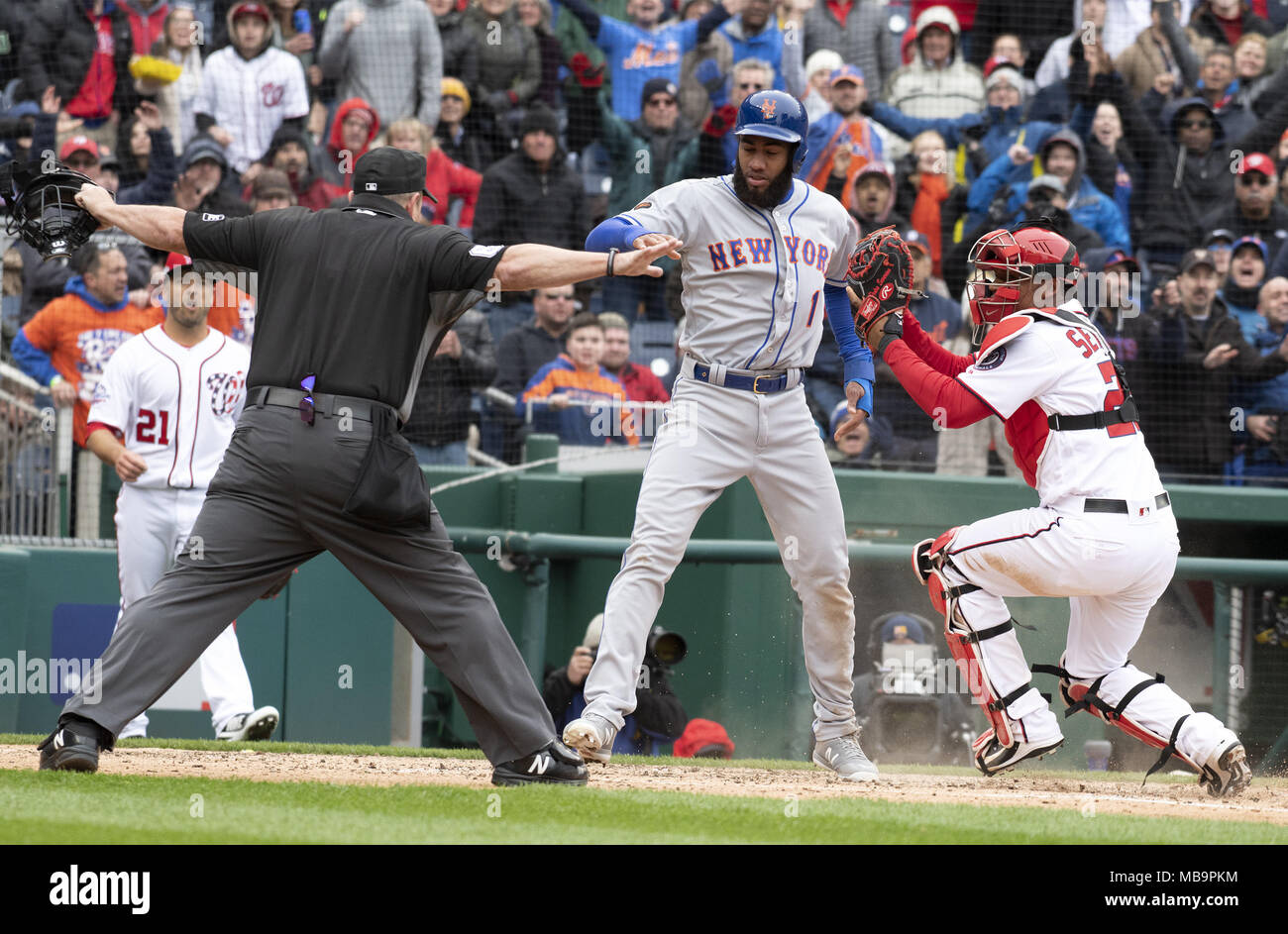 Washington, District of Columbia, USA. 7th Apr, 2018. Home plate umpire Marty Foster (60), left calls New York Mets shortstop Amed Rosario (1), center, safe after he scored on an Asdrubal Cabrera double in the seventh inning against the Washington Nationals at Nationals Park in Washington, DC on Saturday April 7, 2018. Washington Nationals catcher Pedro Severino (29), right, defends on the play. The Mets won the game 3-2.Credit: Ron Sachs/CNP. Credit: Ron Sachs/CNP/ZUMA Wire/Alamy Live News Stock Photo