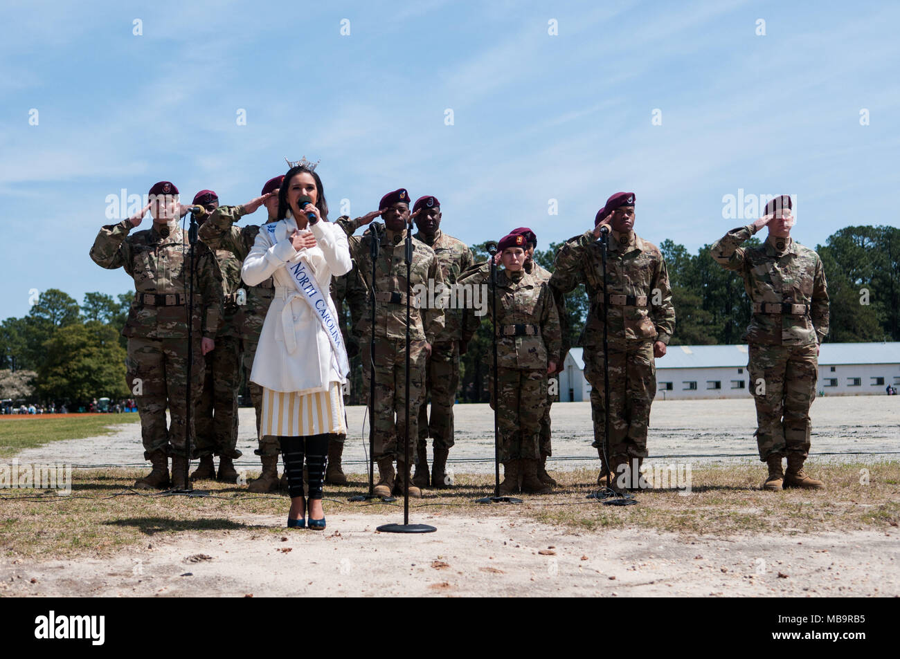 Pinehurst, North Carolina, USA. 8th Apr, 2018. April 8, 2018 - Pinehurst, N.C., USA - Miss North Carolina Victoria Huggins, sings the national anthem in front of the 82nd Airborne Division All American Chorus at the 69th annual Spring Matinee Harness races sponsored by the Pinehurst Driving & Training Club, at the Pinehurst Harness Track, Pinehurst, N.C. The Pinehurst Harness Track is a 111-acre equestrian facility that has been a winter training center for standardbred horses since 1915. This year's races commemorate the 103rd anniversary of the track. (Credit Image: © Timothy L. Hale via Z Stock Photo