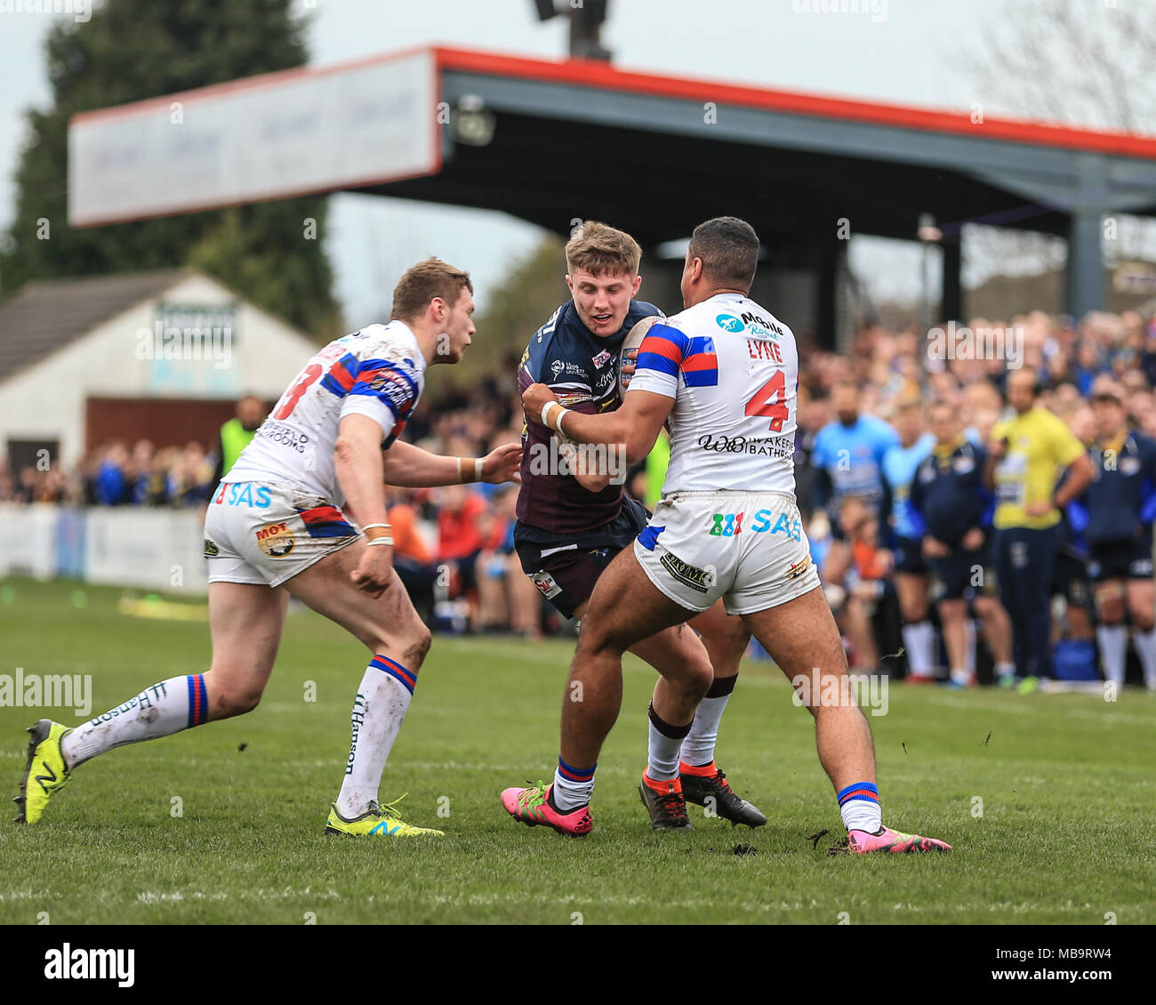 Wakefield, UK. 8th April 2018, Beaumont Legal Stadium, Wakefield, England; Betfred Super League rugby, Wakefield Trinity v Leeds Rhinos;Liam Sutcliffe of Leeds Rhinos is tackled by Reece Lyne of Wakefield Trinity Credit: News Images/Alamy Live News Stock Photo
