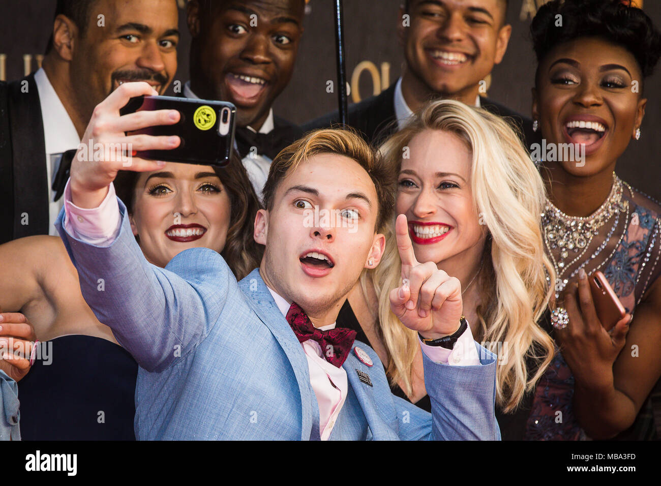 London, UK. 8th April, 2018. The cast of smash hit musical Hamilton pose for selfies in the rain on the red carpet at the 2018 Olivier Awards held at the Royal Albert Hall. Hamilton went on the win a record seven Oliviers including Best New Musical. Credit: David Betteridge/Alamy Live News Stock Photo