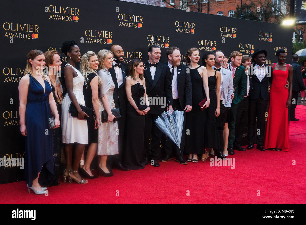 London, UK. 8th April, 2018. The Cast of the Ferryman pos in the rain on the red carpet at the 2018 Olivier Awards held at the Royal Albert Hall. The Ferryman went on to win three Oliviers including Best New Play Credit: David Betteridge/Alamy Live News Stock Photo