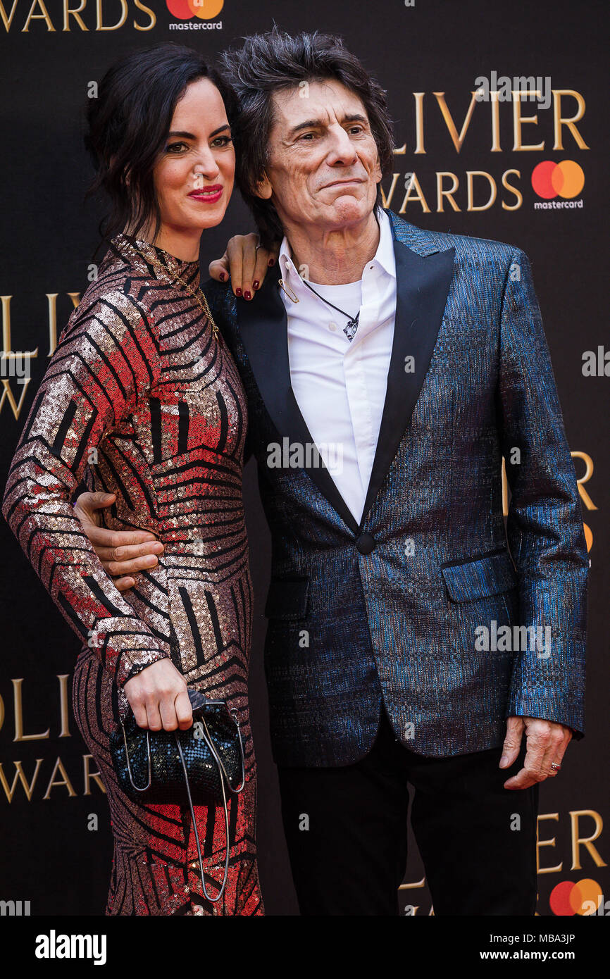 London, UK. 8th April, 2018. Rolling Stone Guitarist Ronnie Wood with his wife Sally pose in the rain on the red carpet at the 2018 Olivier Awards held at the Royal Albert Hall in London Credit: David Betteridge/Alamy Live News Stock Photo
