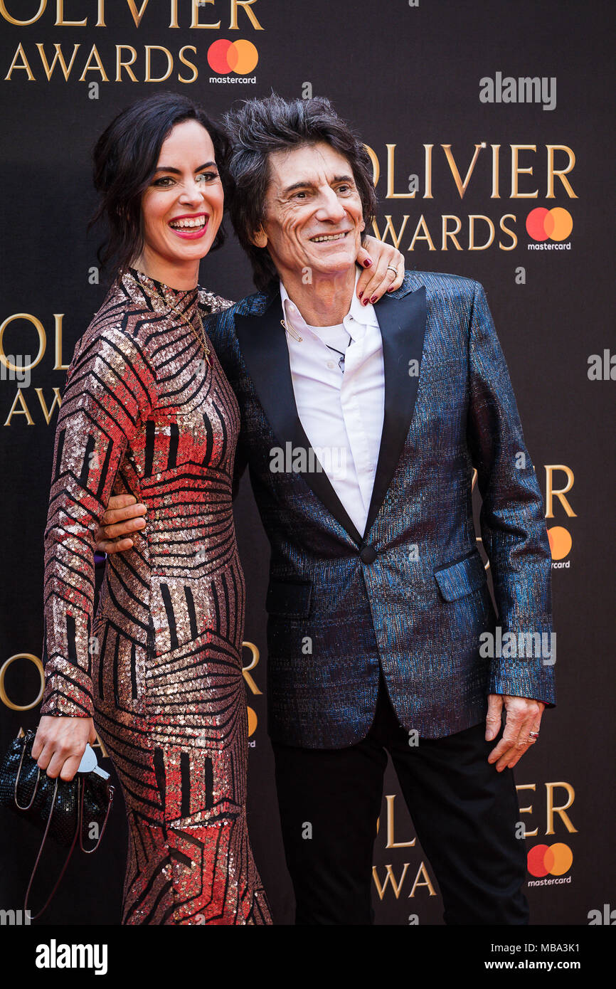 London, UK. 8th April, 2018. Rolling Stone Guitarist Ronnie Wood with his wife Sally pose in the rain on the red carpet at the 2018 Olivier Awards held at the Royal Albert Hall in London Credit: David Betteridge/Alamy Live News Stock Photo