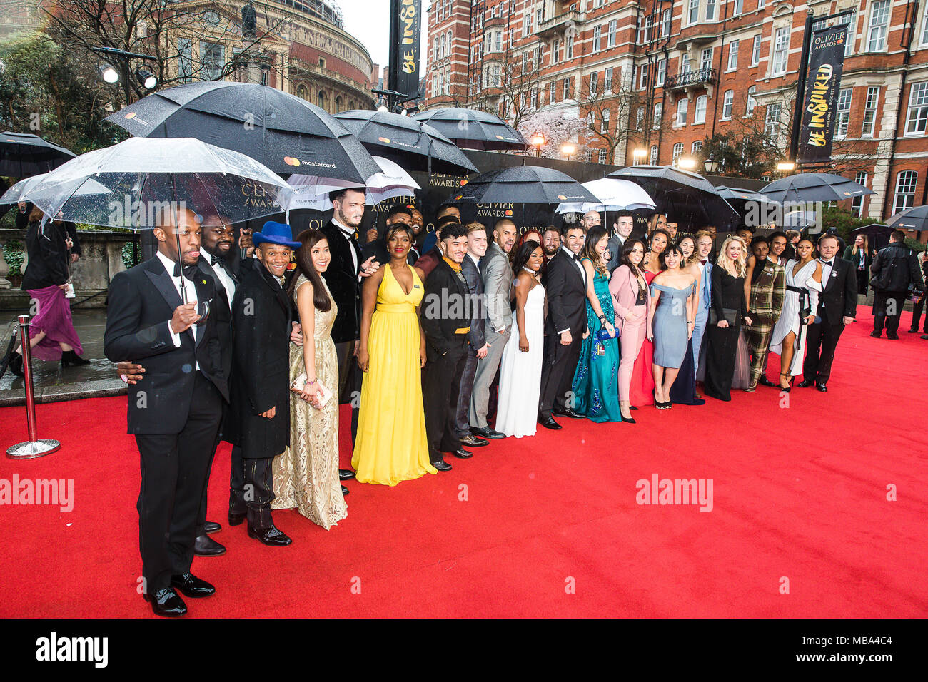 London, UK. 8th April, 2018. The cast of smash hit musical Hamilton pose in the rain on the red carpet at the 2018 Olivier Awards held at the Royal Albert Hall. Hamilton went on the win a record seven Oliviers including Best New Musical. Credit: David Betteridge/Alamy Live News Stock Photo