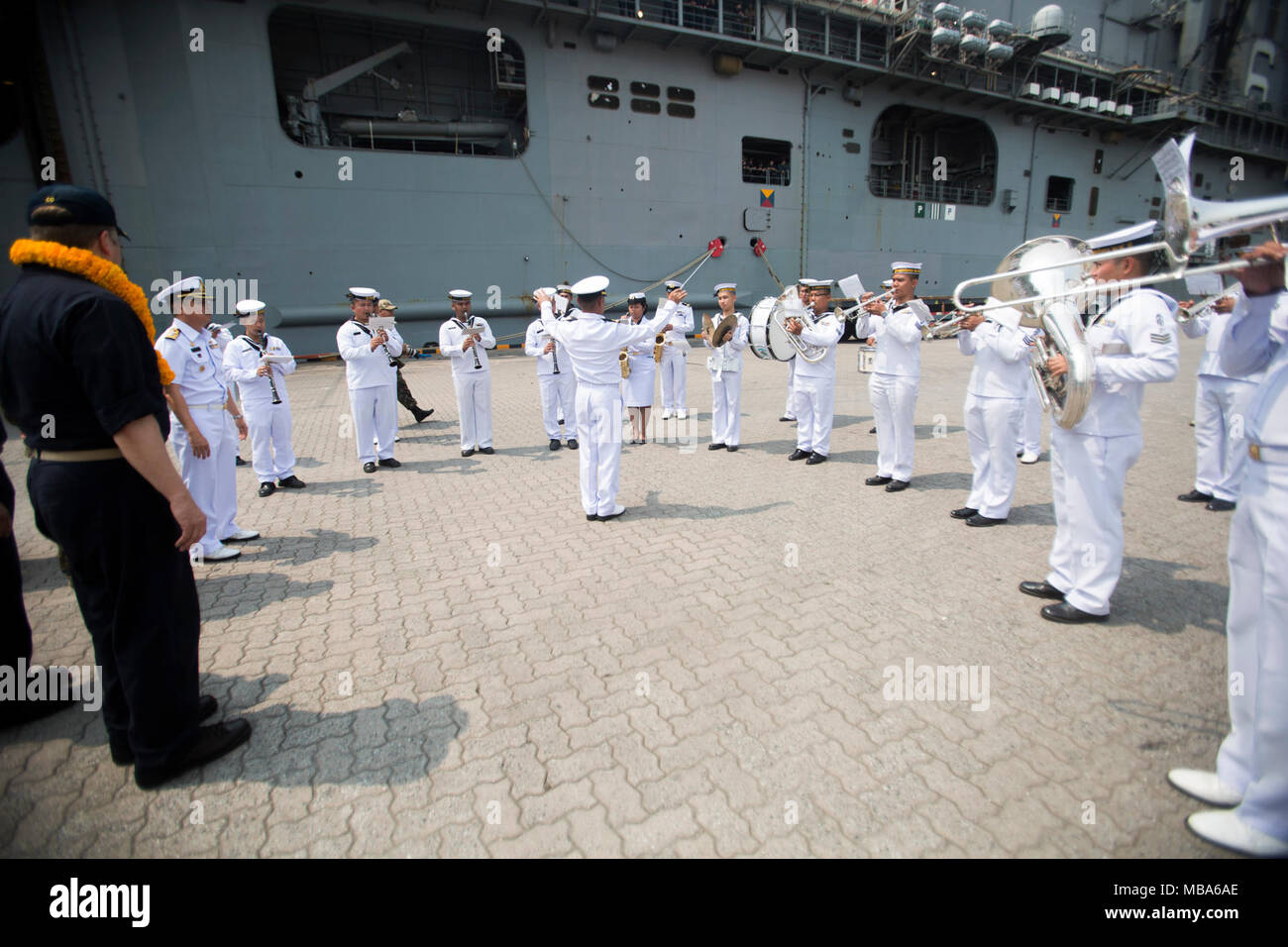 The Royal Thai Navy Band performs during the arrival of the USS Bonhomme Richard (LHD 6) at Laem Chabang International Terminal, Thailand, Feb. 11, 2018. The Bonhomme Richard is a Wasp-class amphibious assault ship with a home port in Sasebo, Japan. While in port, the Bonhomme Richard will embark U.S. Marine and Navy personnel, vehicles and equipment before sailing alongside the Royal Thai Navy and Republic of Korea ships as part of Exercise Cobra Gold 18, an annual exercise conducted in the Kingdom of Thailand held from Feb. 13-23 with seven nations participating. (U.S. Marine Corps Stock Photo