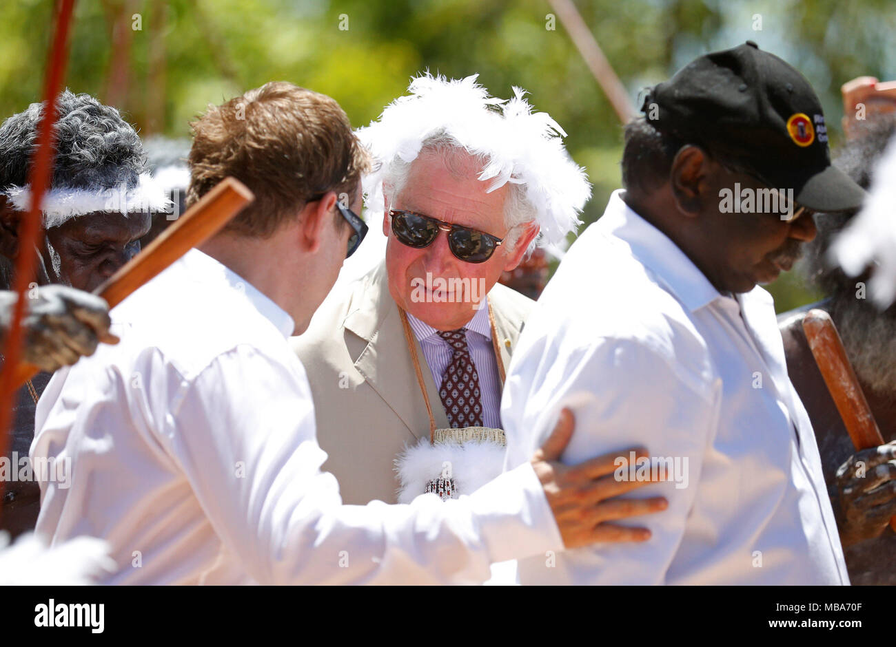 The Prince of Wales wears a mulka string, a feather stringed headband, as he takes part in a traditional welcome ceremony during a visit to Mount Nhulun in Nhulunbuy, in Australia's Northern Territory. Stock Photo