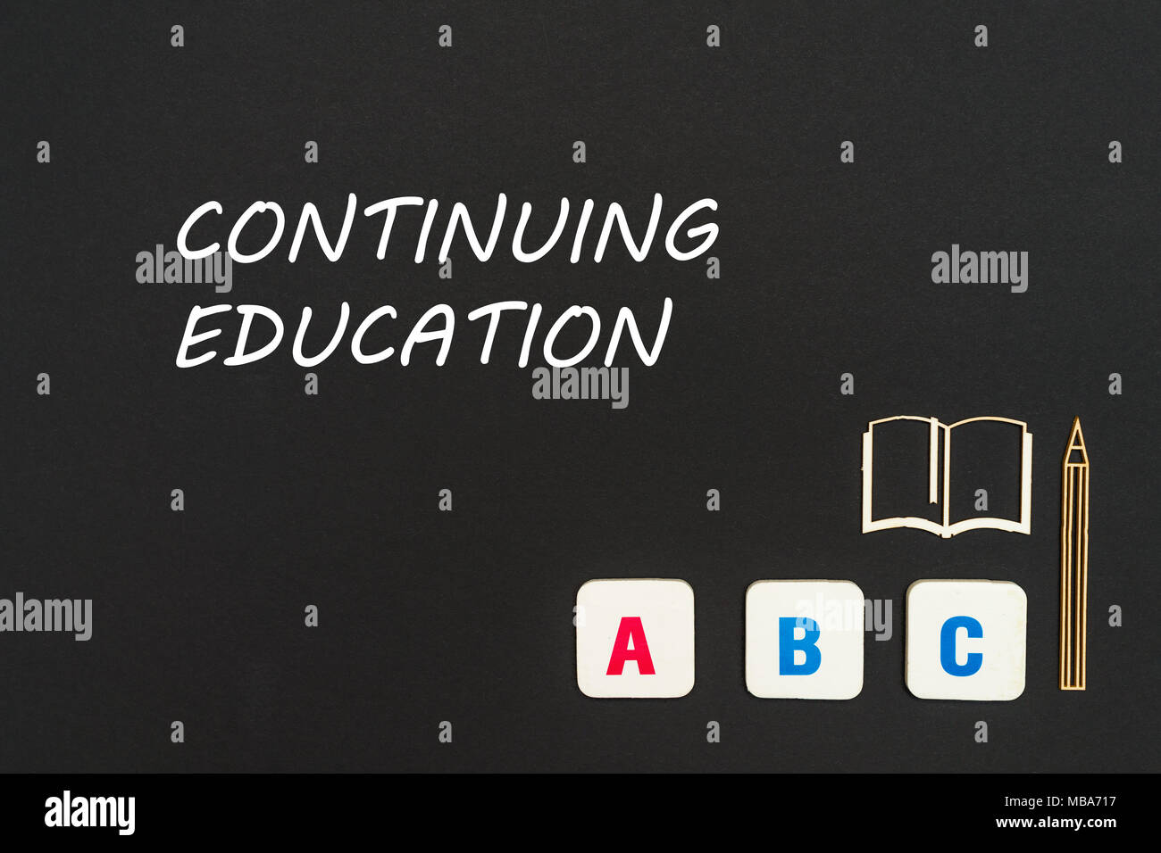 concept english school, text continuing education, abc letters, chipboard miniature book, pen on