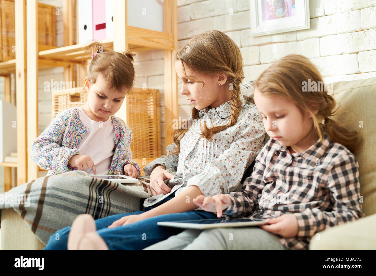 Tech-Savvy Little Sisters Stock Photo