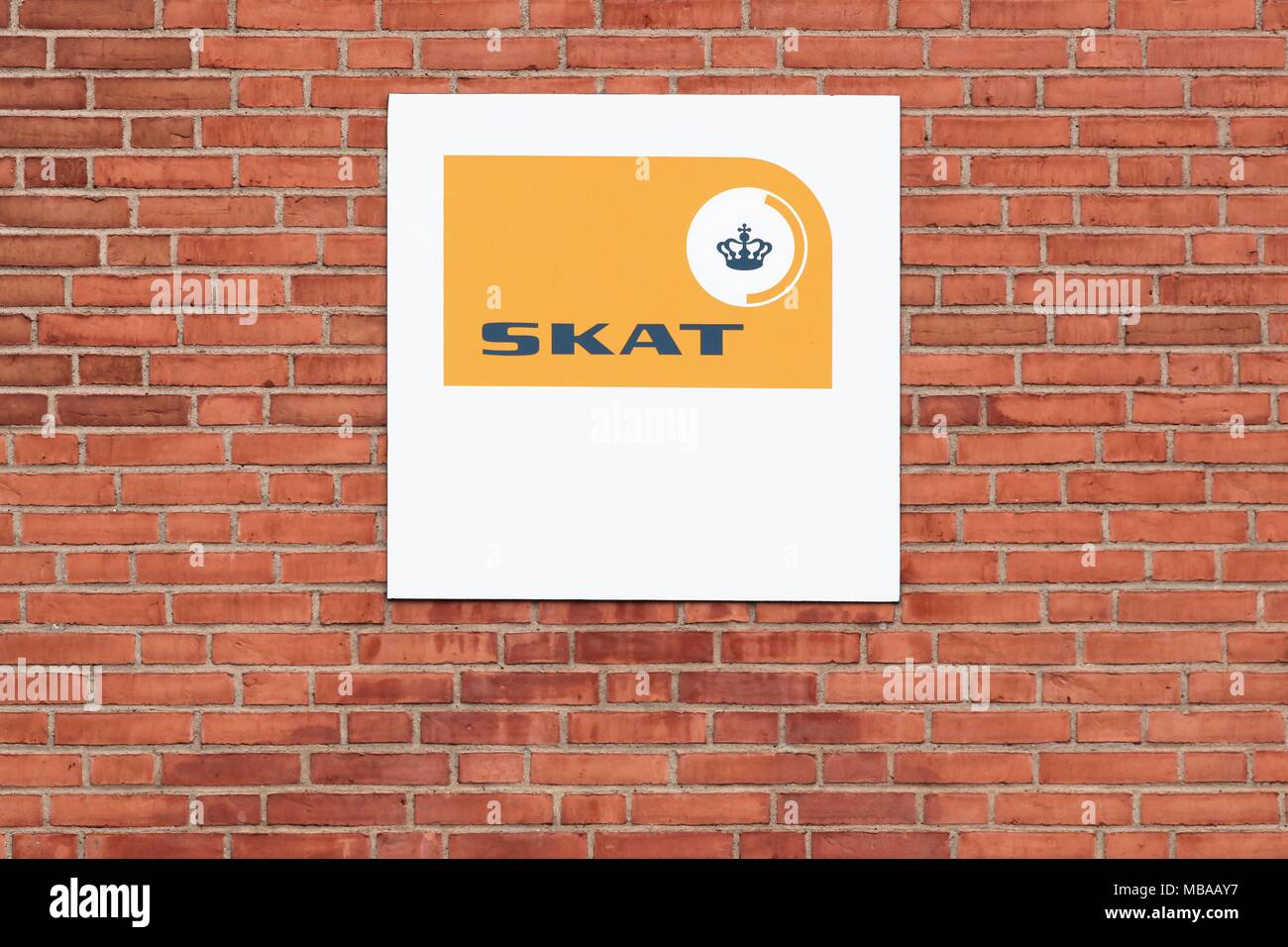 Horsens, Denmark - April  1, 2018: Danish tax authority logo on a wall called Skat in Danish Stock Photo
