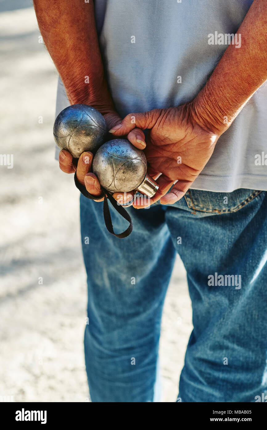 Man playing Petanque in a French village Stock Photo