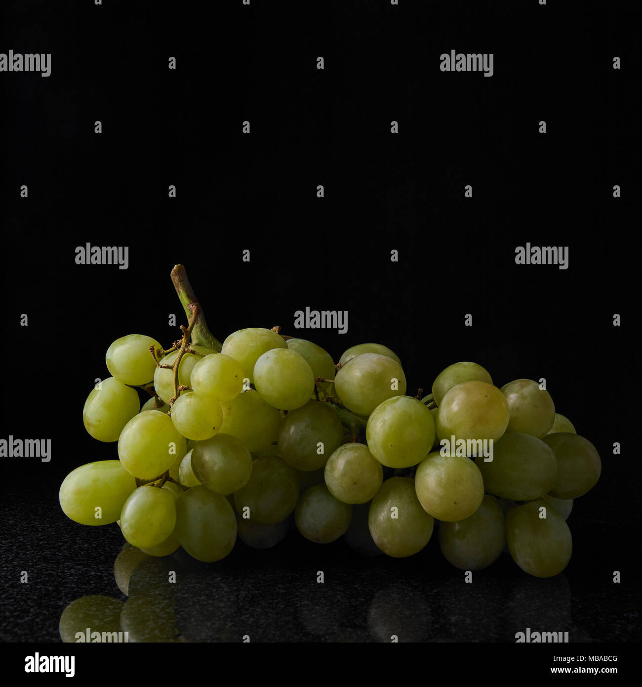 White seedless grapes on black background Stock Photo - Alamy