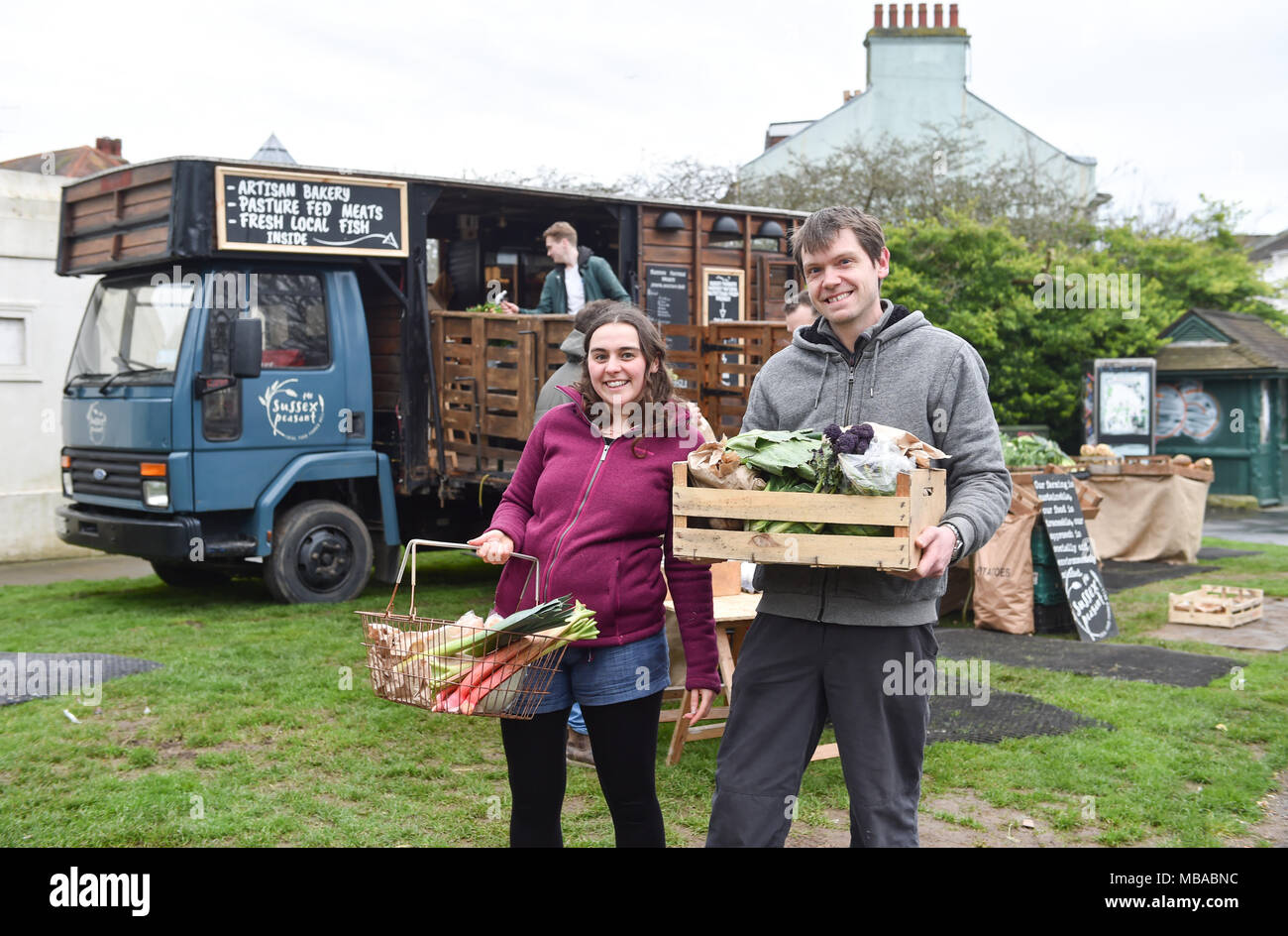 Customers buying their weekly fresh vegetables from The Sussex Peasant mobile farm shop set up beside the Pepper Pot in Brighton Stock Photo