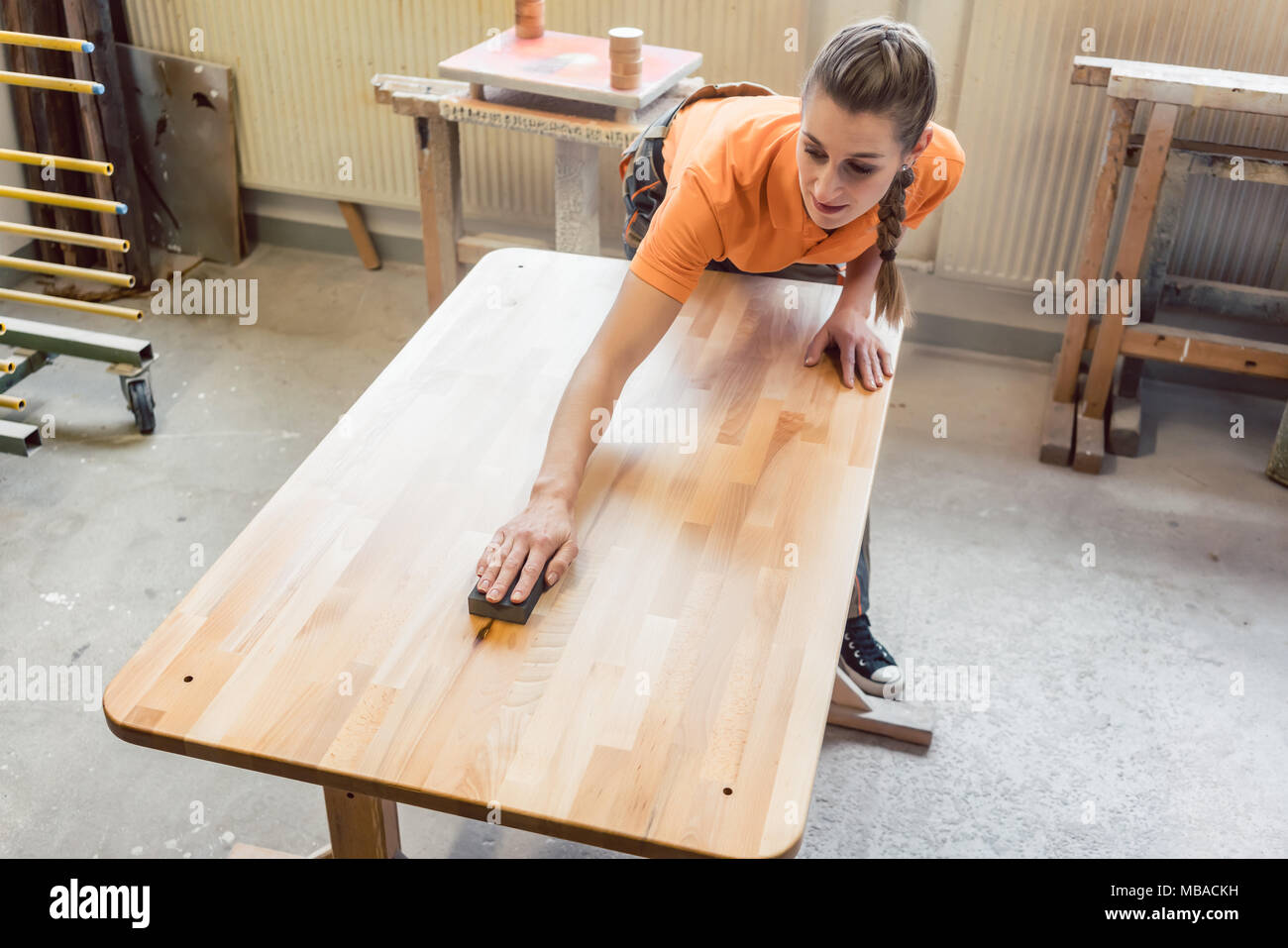 Carpenter woman working on a table Stock Photo
