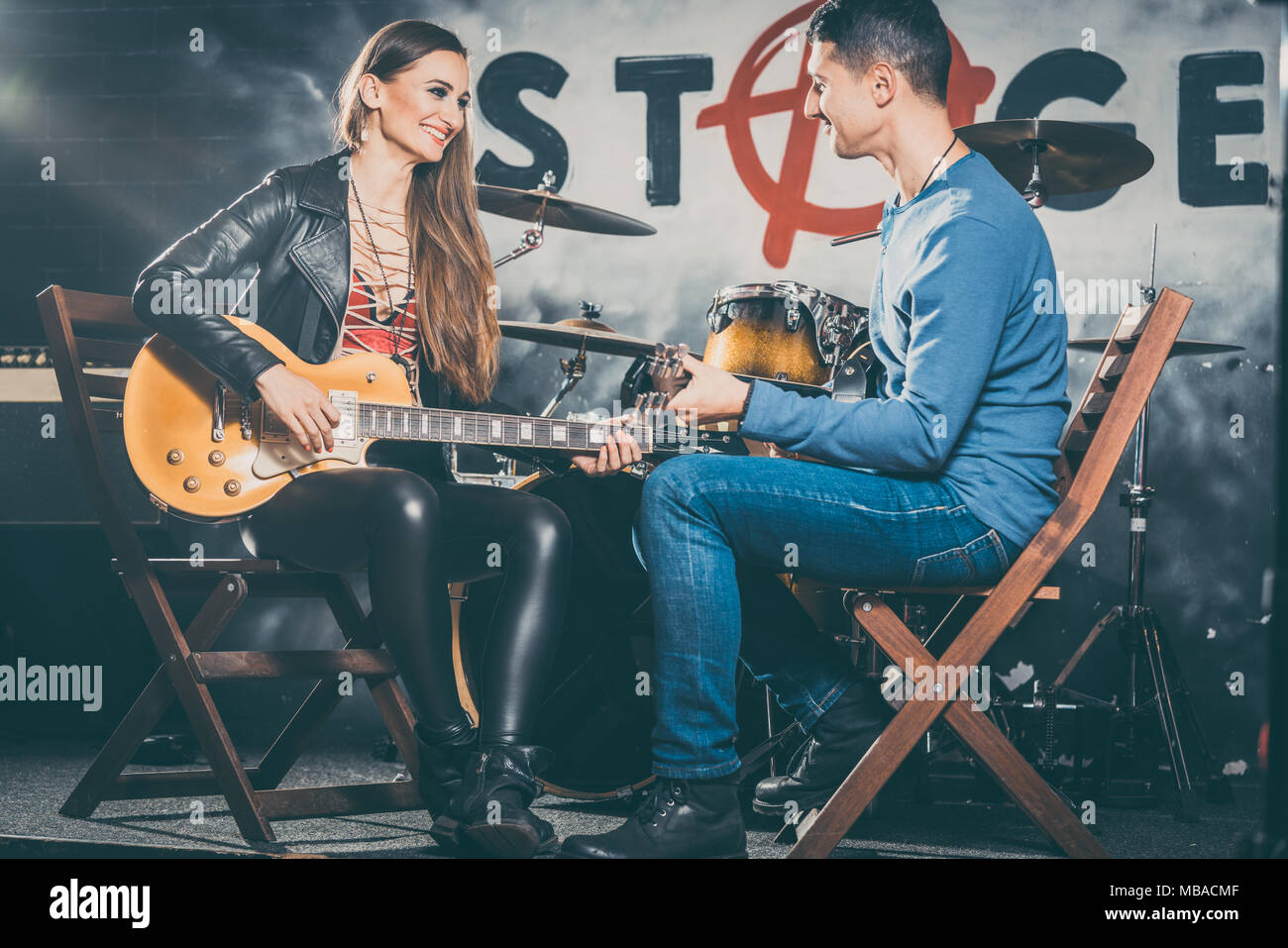 Woman taking guitar lessons with music teacher  Stock Photo