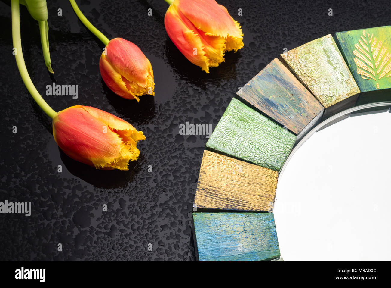 Interior design mirror handmade in wooden frame with bouquet of spring tulips Stock Photo