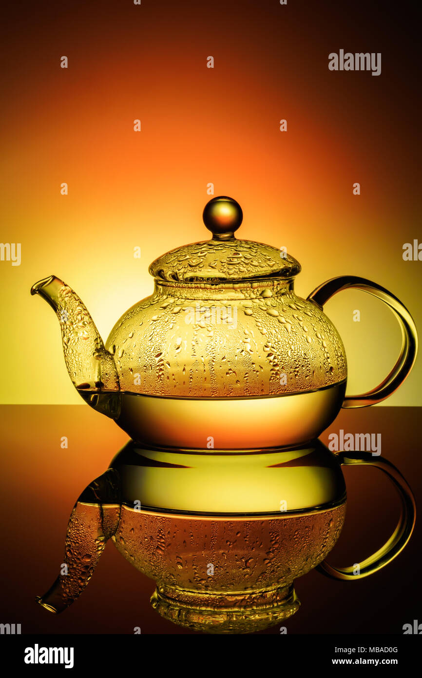 Glass teapot with boiling water and drops of condensation Stock Photo