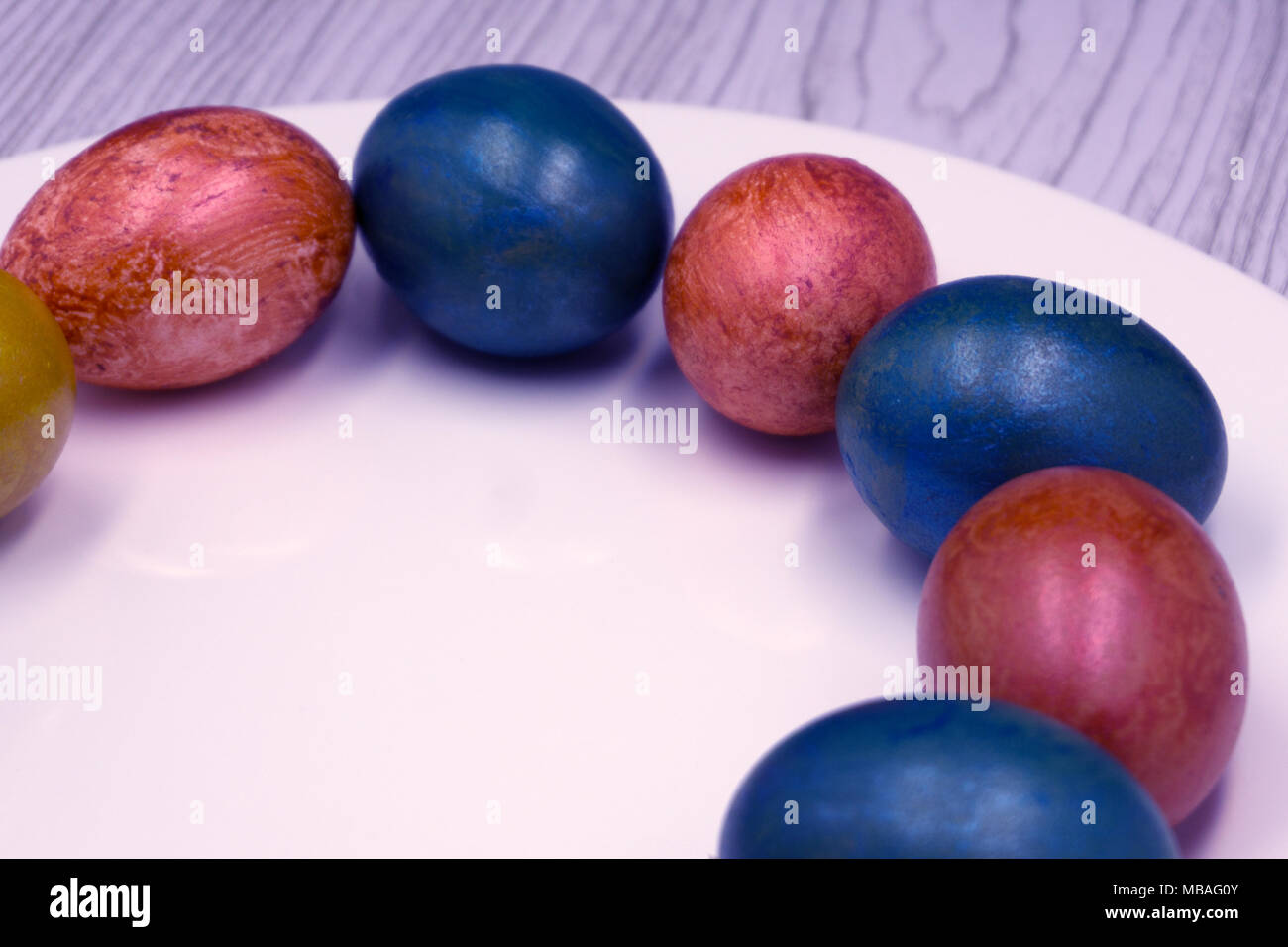 Basket with easter cake and red eggs on rustic wooden table. Top view Stock Photo