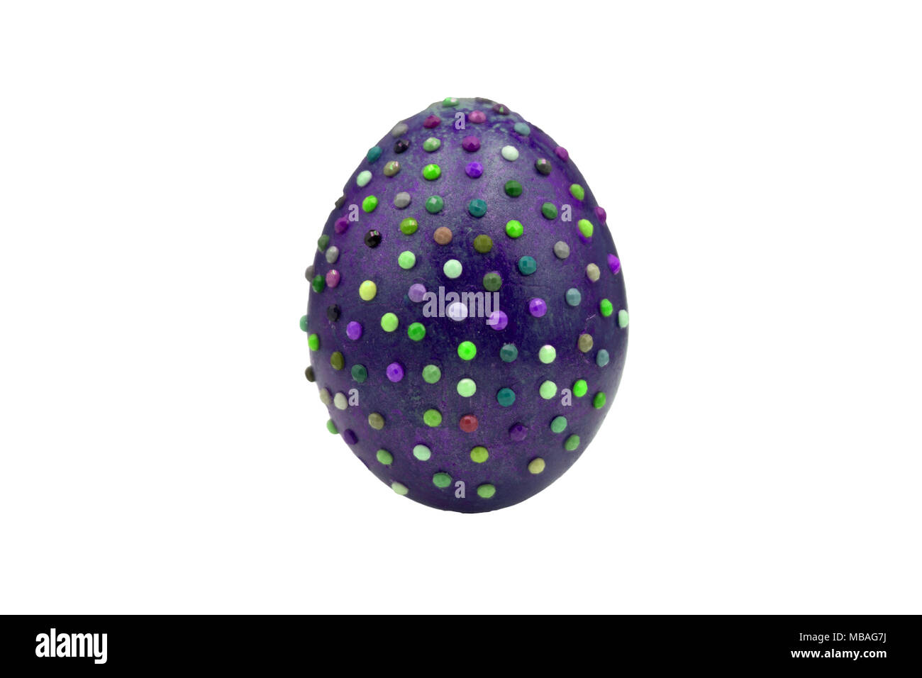 One marble textured stone epensive violet and fashionable easter egg on a gold stand for easter holidays. Perfect for a designer eastern table or setu Stock Photo