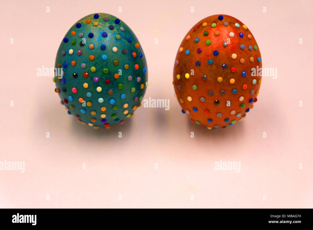 Decorated Easter eggs in a bowl, closeup on pastel background Stock Photo