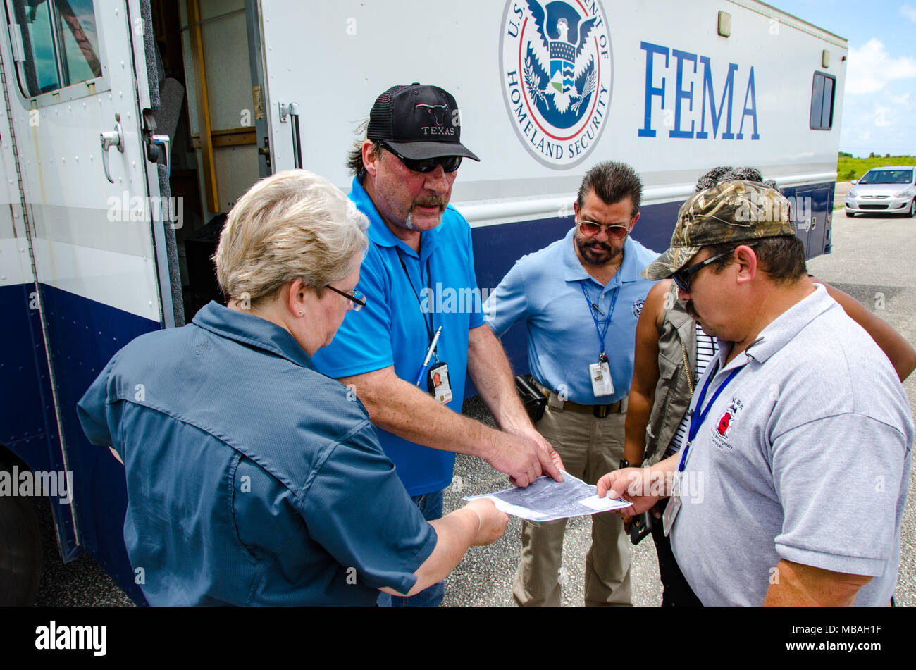 Aguadilla, P.R.--FEMA External Support Branch Director Linwood Gantt Jr.(black cap), and his team are at the Rafael Hernandez Airport to set up an Incident Support Base (ISB) and coordinate delivery of supplies to support the response to Hurricane Irma. Stock Photo