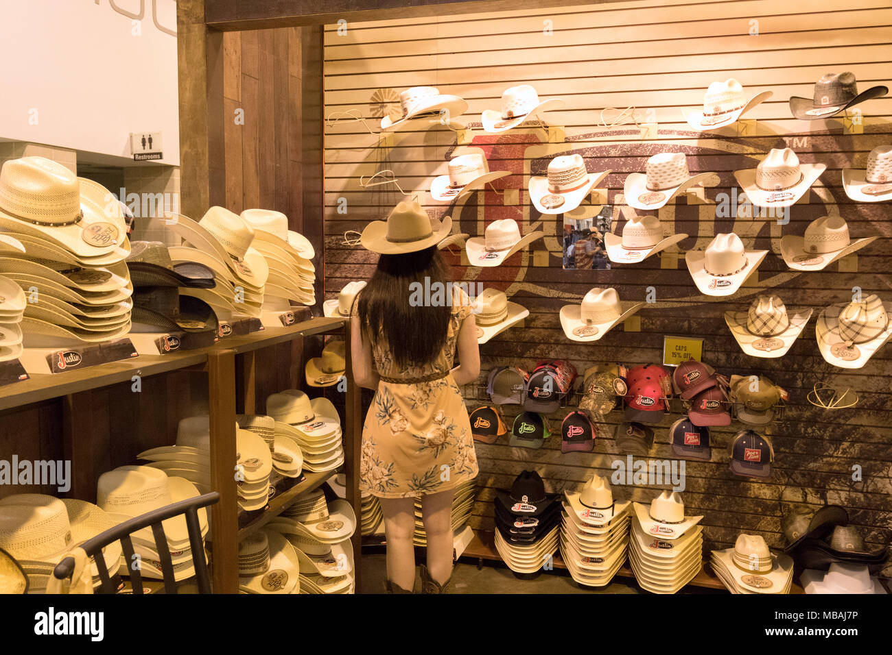 Woman in a cowboy hat store, Houston Livestock Show and Rodeo, Houston, Texas USA Stock Photo