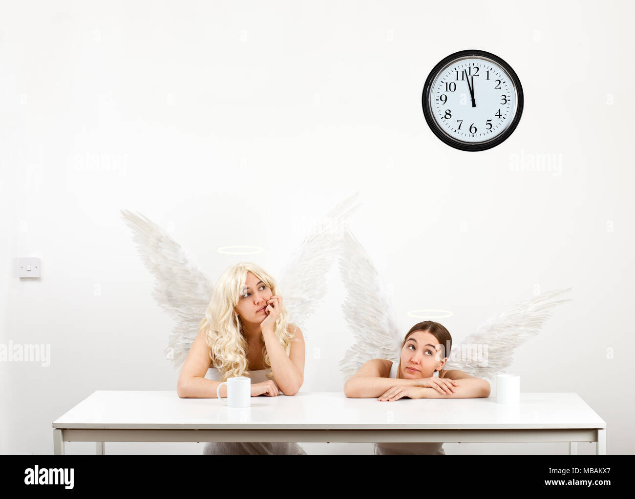 Two angels having a coffee break (copy of Raphael's 'Little Angels' in the Sistine Madonna) Stock Photo