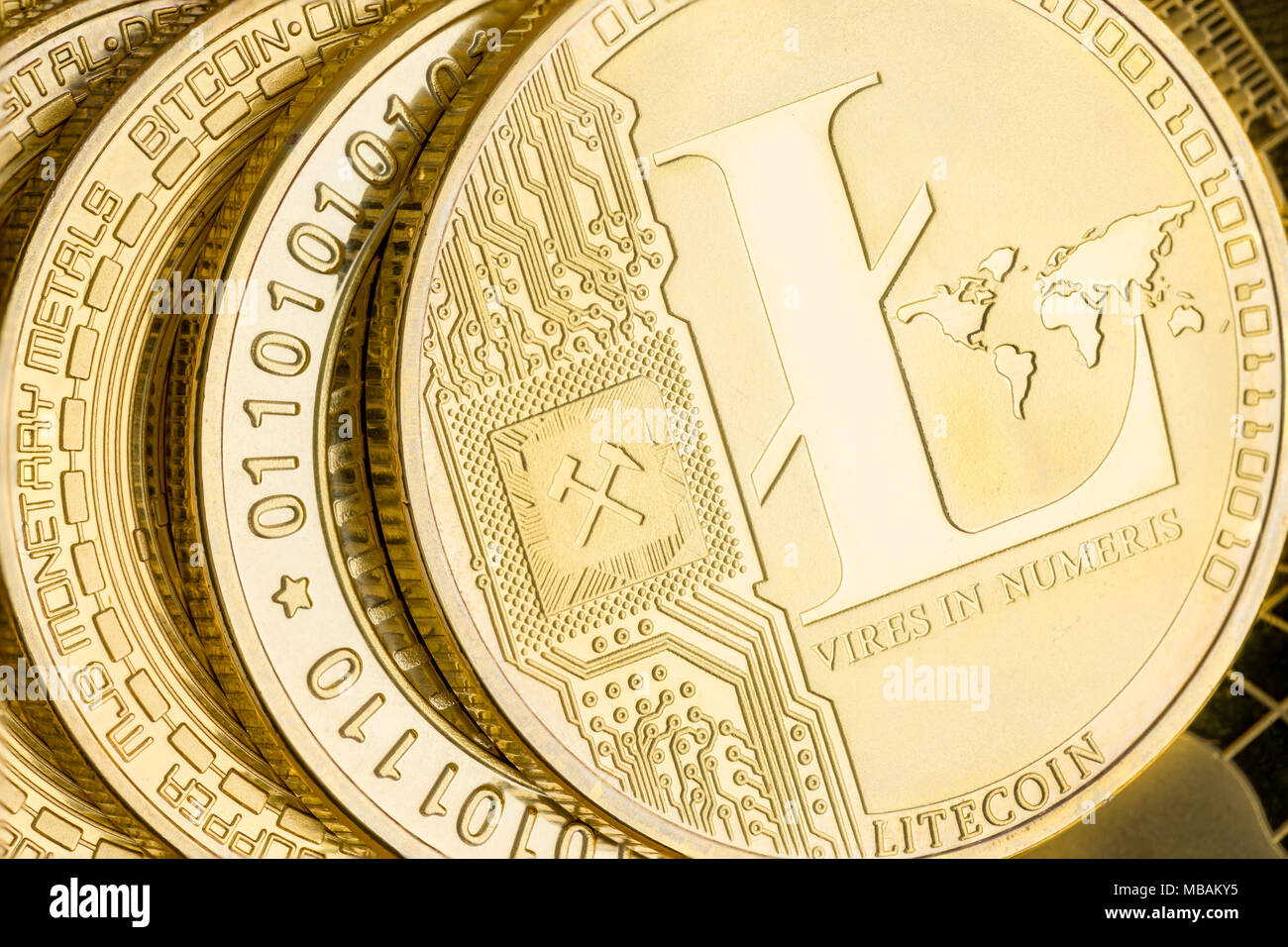 Detail of a gold Litecoin cryptocurrency coin showing the design and  embossing on a stack of coins in a financial, investment, exchange and  peer-to-pe Stock Photo - Alamy
